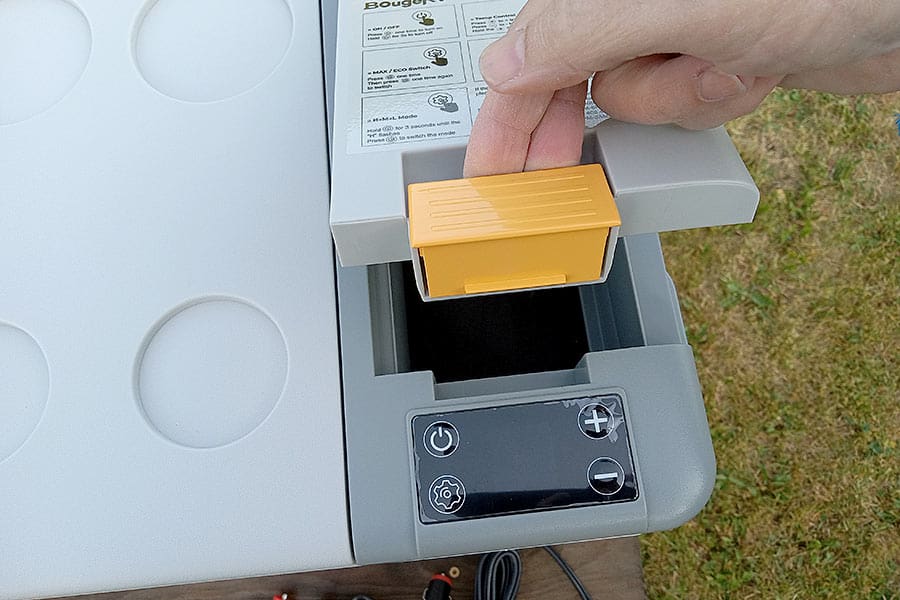 Refrigerator battery compartment door